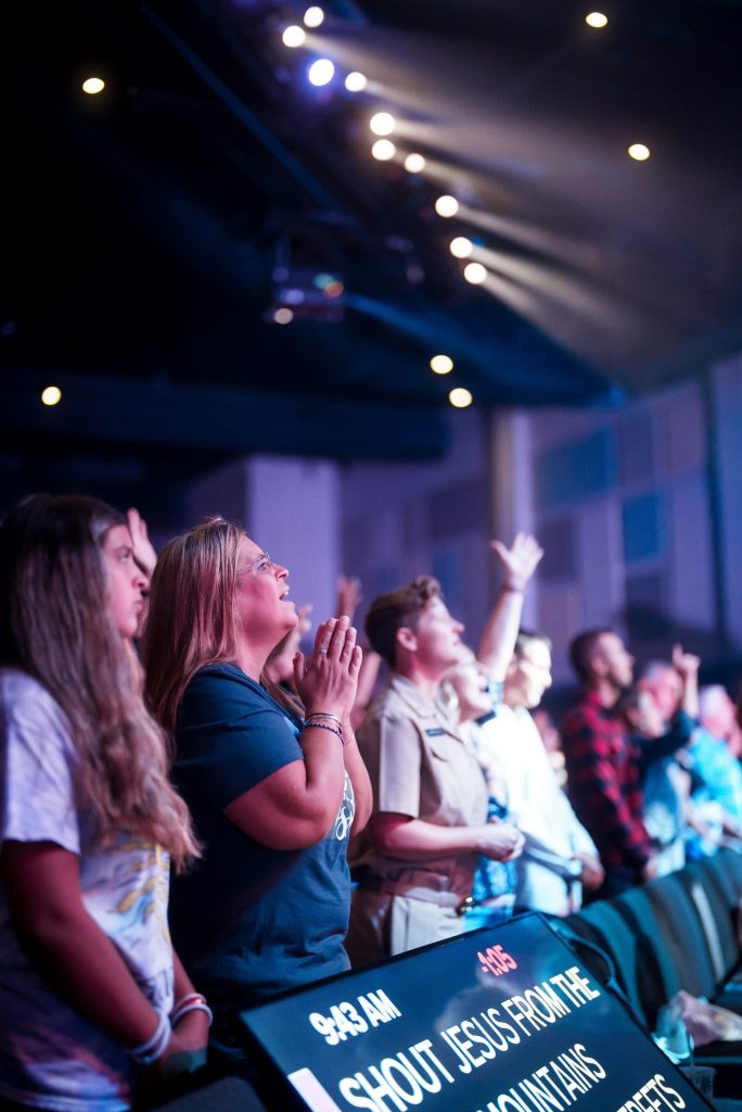 a group of people standing in front of a crowd of people
